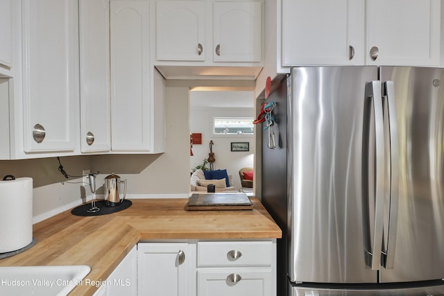 33 Cottonwood Ln, Woodstock, NY 12498 - kitchen with freestanding refrigerator, wood counters, and white cabinetry