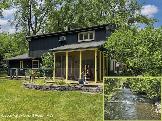 33 Cottonwood Ln, Woodstock, NY 12498 - view of front of house featuring a sunroom, a front lawn, and an AC wall unit