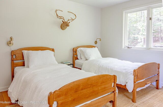 36 Ridgewood Rd, Kerhonkson, NY 12446 - bedroom with multiple windows, baseboards, and light wood-type flooring