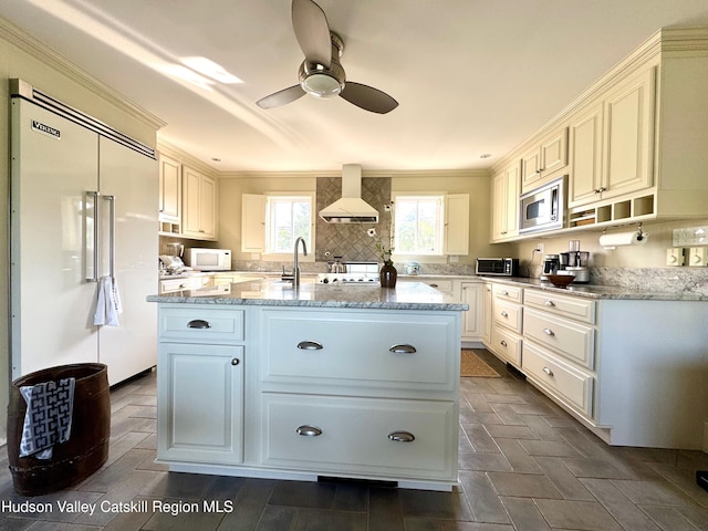 110 County Route 7a, Copake, NY 12516 - kitchen featuring built in appliances, custom exhaust hood, crown molding, a ceiling fan, and a center island with sink