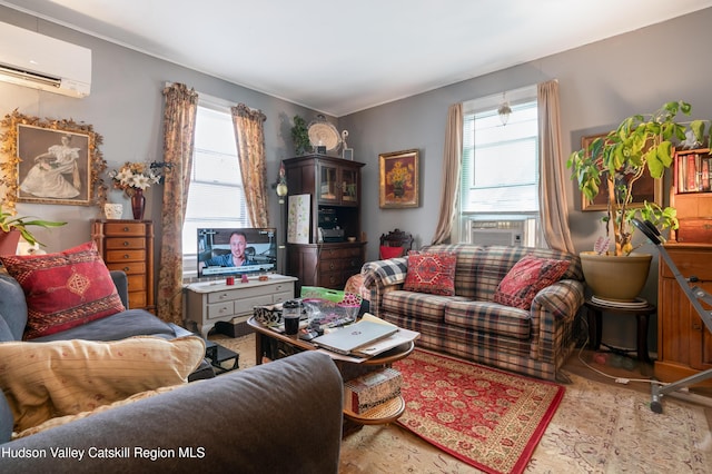 living area featuring cooling unit, a healthy amount of sunlight, and a wall mounted AC