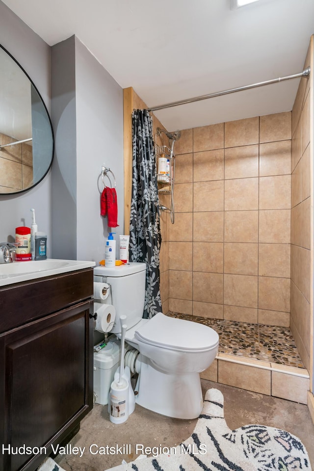 bathroom with vanity, toilet, and a stall shower