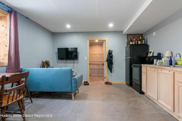 living room with recessed lighting and concrete flooring