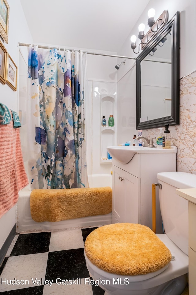 full bath with vanity, toilet, and shower / bath combo