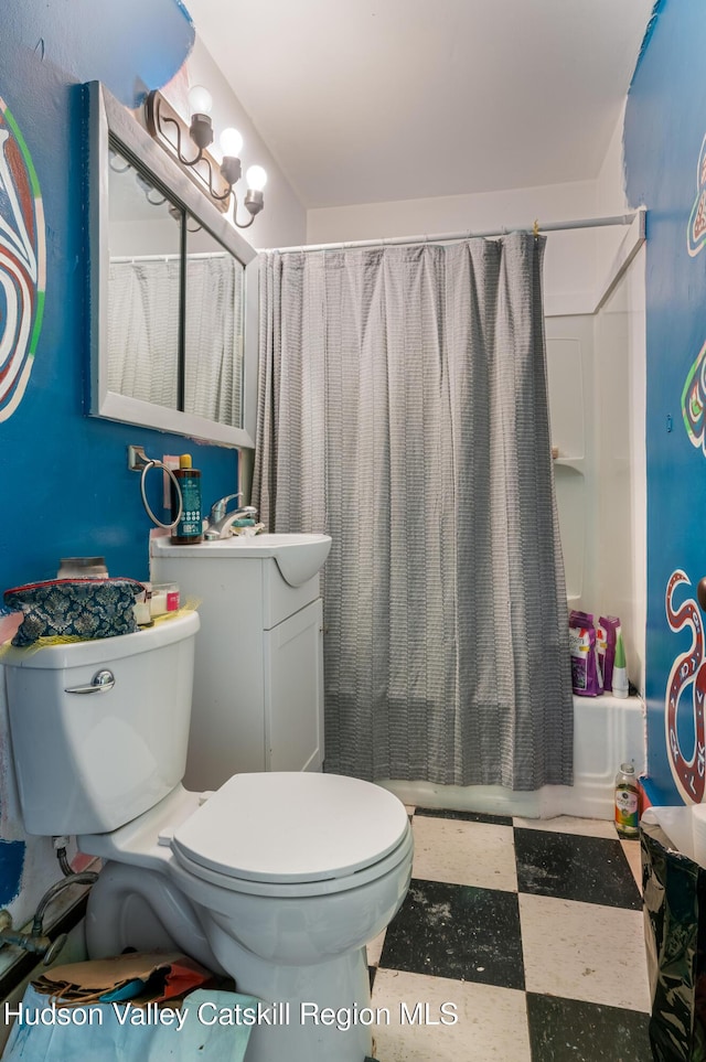full bath with vanity, tile patterned floors, toilet, and shower / bath combo with shower curtain