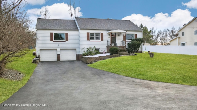 view of front facade with a front yard and a garage