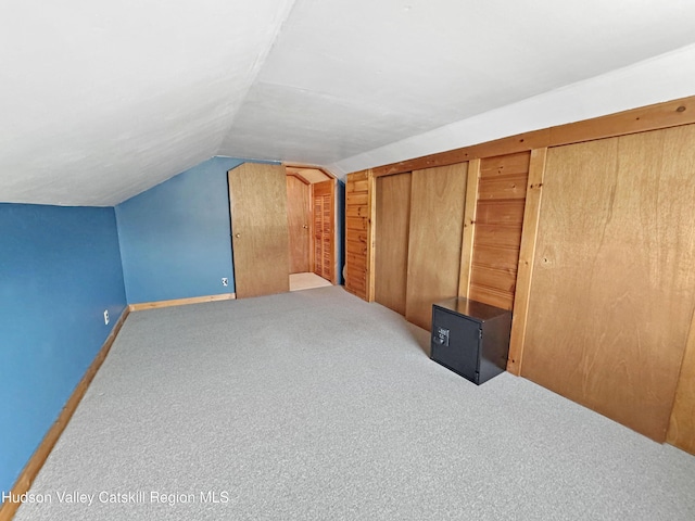 bonus room featuring carpet flooring and vaulted ceiling