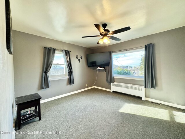 living room featuring crown molding, radiator, and light hardwood / wood-style flooring