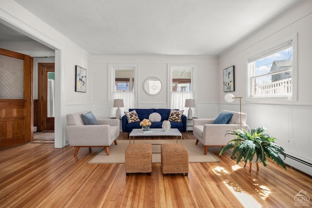 7 Mckinstry Pl, Hudson, NY 12534 - living area featuring light wood-type flooring, a wainscoted wall, a decorative wall, and a baseboard radiator