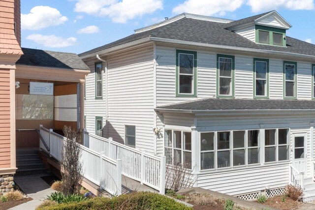 7 Mckinstry Pl, Hudson, NY 12534 - rear view of house featuring a shingled roof and a sunroom