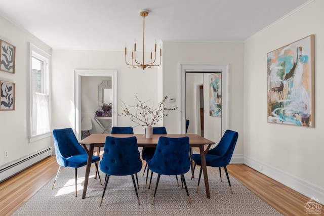 7 Mckinstry Pl, Hudson, NY 12534 - dining room featuring baseboard heating, wood finished floors, a chandelier, crown molding, and baseboards