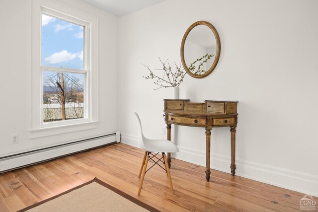 7 Mckinstry Pl, Hudson, NY 12534 - unfurnished room with a baseboard heating unit, wood finished floors, and healthy amount of natural light