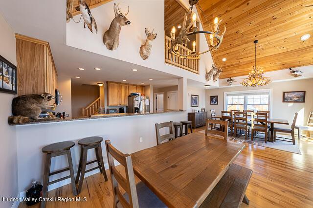 TBD Aden Hill Rd, Neversink, NY 12765 - dining space featuring a chandelier, light wood-style floors, recessed lighting, high vaulted ceiling, and stairs