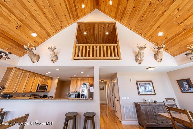 TBD Aden Hill Rd, Neversink, NY 12765 - dining area with wooden ceiling, an inviting chandelier, wood finished floors, high vaulted ceiling, and a stone fireplace