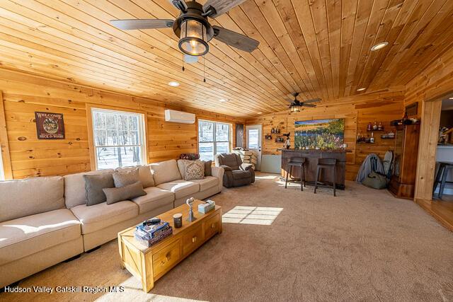 TBD Aden Hill Rd, Neversink, NY 12765 - carpeted living room with wooden ceiling, a ceiling fan, wood walls, a wall mounted AC, and a bar