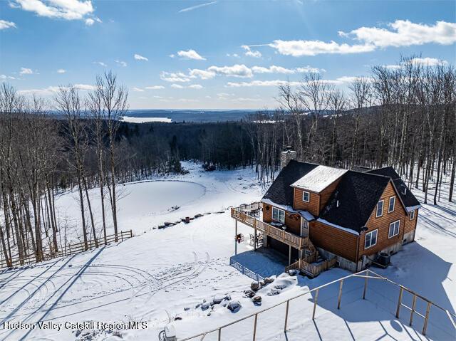 TBD Aden Hill Rd, Neversink, NY 12765 - snow covered house with a chimney, a shingled roof, and a deck