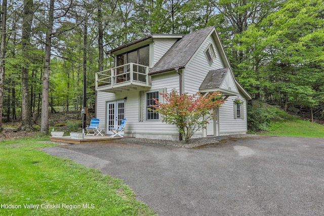 view of front of house featuring french doors and a balcony