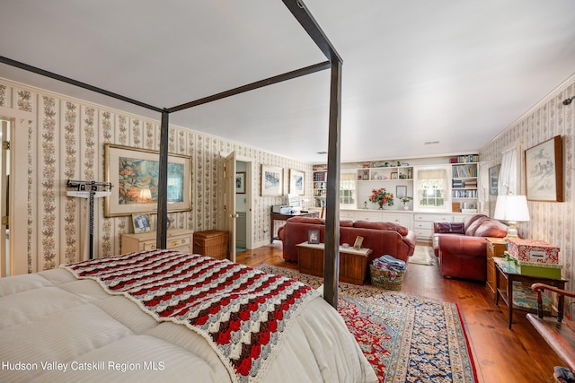 bedroom with wood-type flooring and ornamental molding