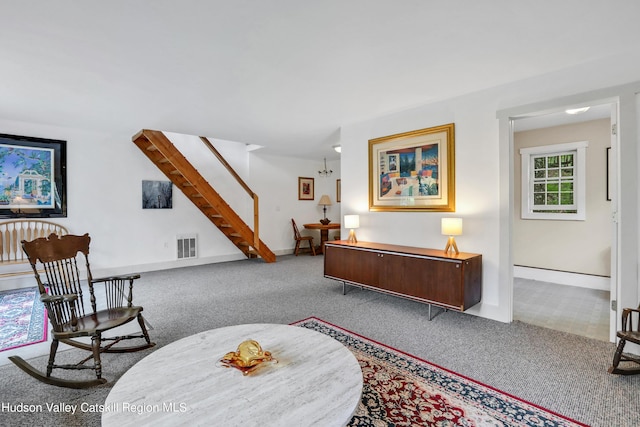 living area with light colored carpet and a notable chandelier