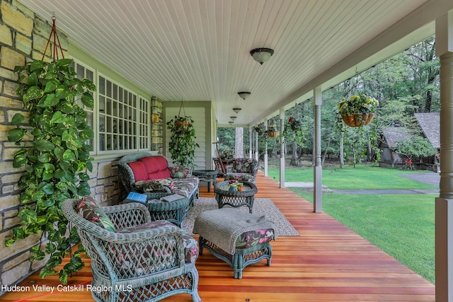 wooden deck with a porch and a yard