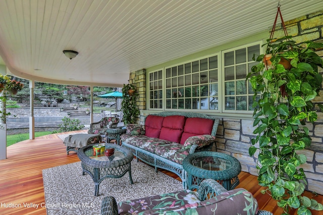 wooden deck featuring an outdoor living space and a porch