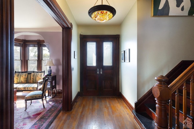 44 Worth Ave, Hudson, NY 12534 - entrance foyer featuring baseboards, plenty of natural light, wood finished floors, and arched walkways