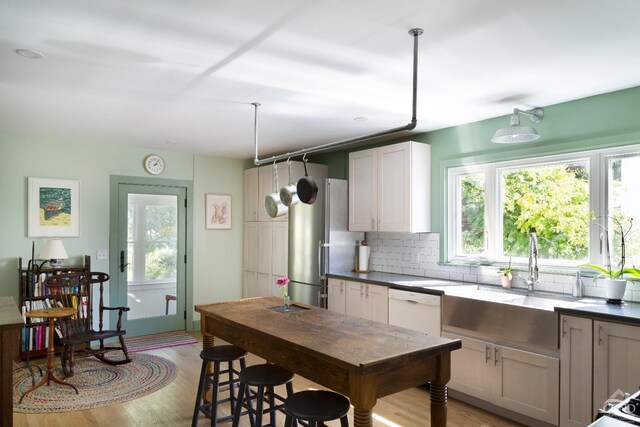 44 Worth Ave, Hudson, NY 12534 - kitchen with healthy amount of natural light, a sink, tasteful backsplash, and light wood-style floors