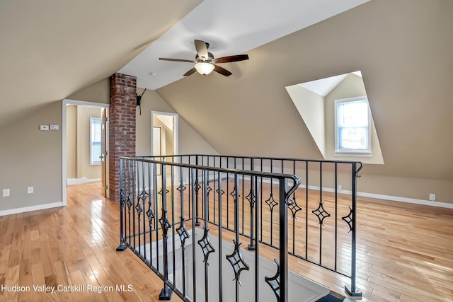 interior space featuring ceiling fan, vaulted ceiling, and light hardwood / wood-style flooring