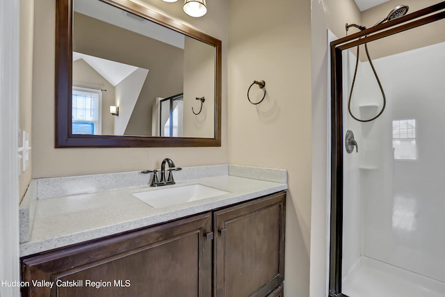 bathroom with vanity and a shower with shower door