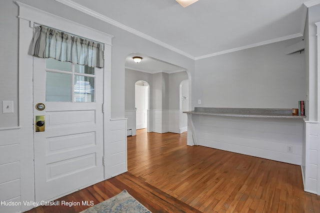 entrance foyer with hardwood / wood-style flooring and crown molding