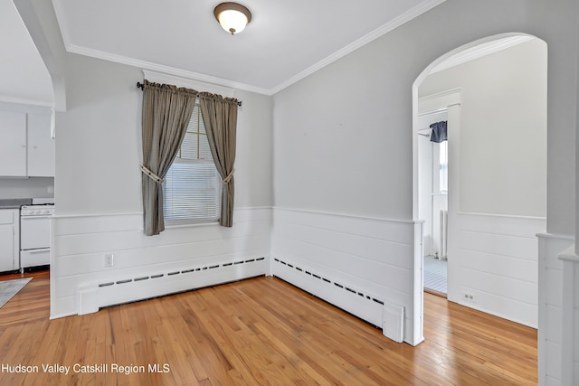 unfurnished room with a baseboard radiator, ornamental molding, and light hardwood / wood-style floors