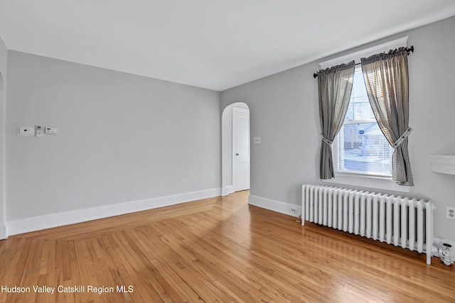 empty room featuring light hardwood / wood-style floors and radiator