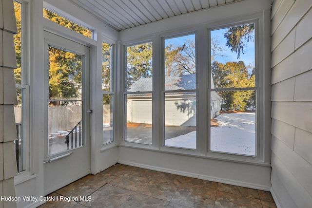 unfurnished sunroom with a wealth of natural light