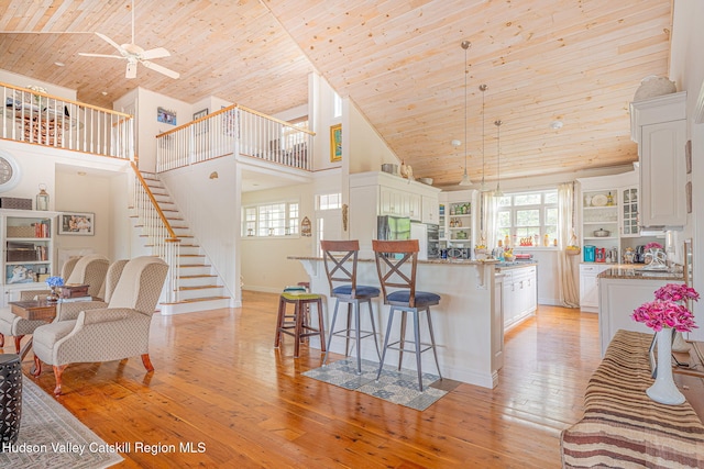 8 Story Ct Unit I 73, Athens, NY 12015 - kitchen with wooden ceiling, high vaulted ceiling, a kitchen breakfast bar, white cabinets, and a peninsula