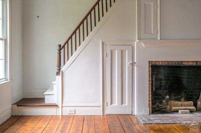 1606 Bulls Head Rd, Stanfordville, NY 12581 - staircase featuring hardwood / wood-style flooring and a fireplace with raised hearth