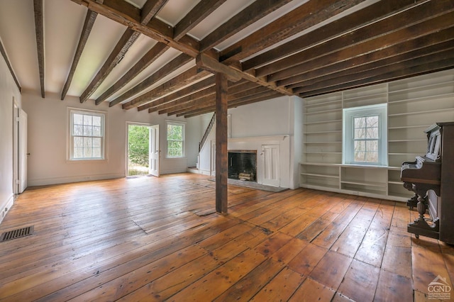 1606 Bulls Head Rd, Stanfordville, NY 12581 - unfurnished living room with wood-type flooring, a fireplace, beamed ceiling, and baseboards