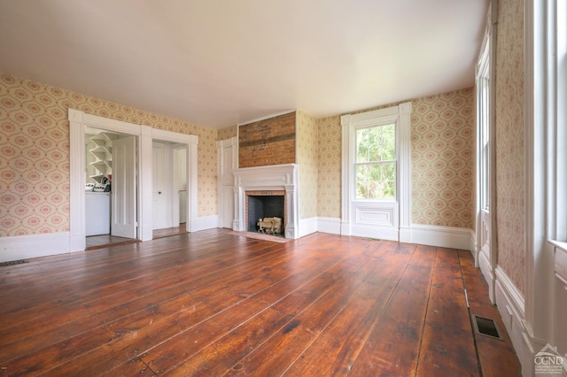 1606 Bulls Head Rd, Stanfordville, NY 12581 - unfurnished living room with wallpapered walls, wood-type flooring, and a fireplace with flush hearth