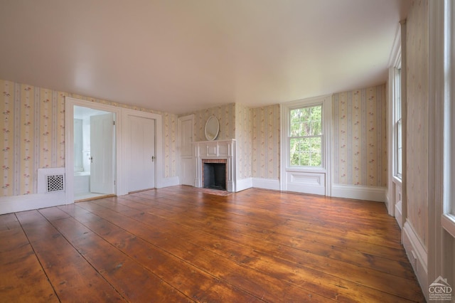 1606 Bulls Head Rd, Stanfordville, NY 12581 - unfurnished living room with wallpapered walls, wood-type flooring, and a fireplace with flush hearth