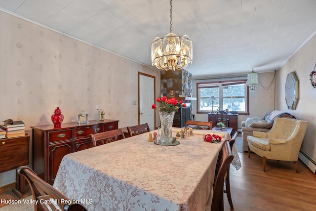 dining room featuring wood-type flooring and an inviting chandelier