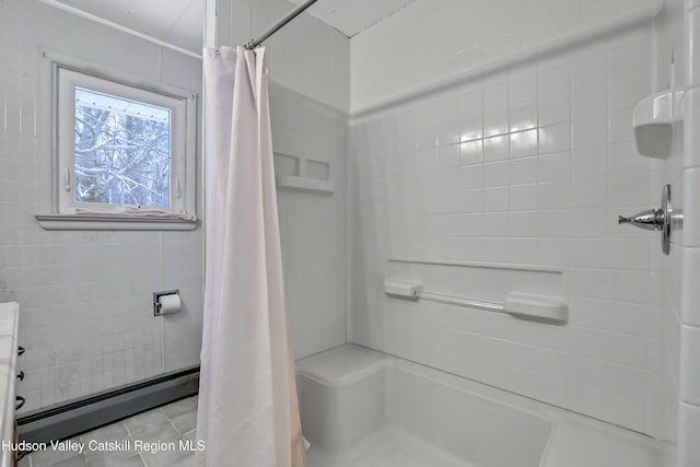 bathroom with a baseboard radiator and curtained shower