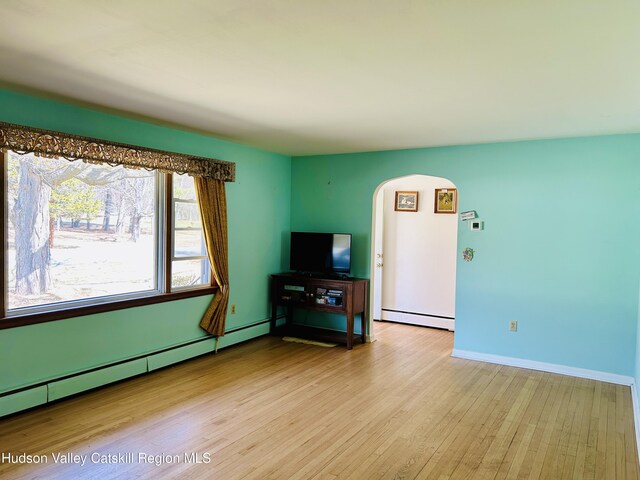 living area featuring baseboard heating and light wood-type flooring