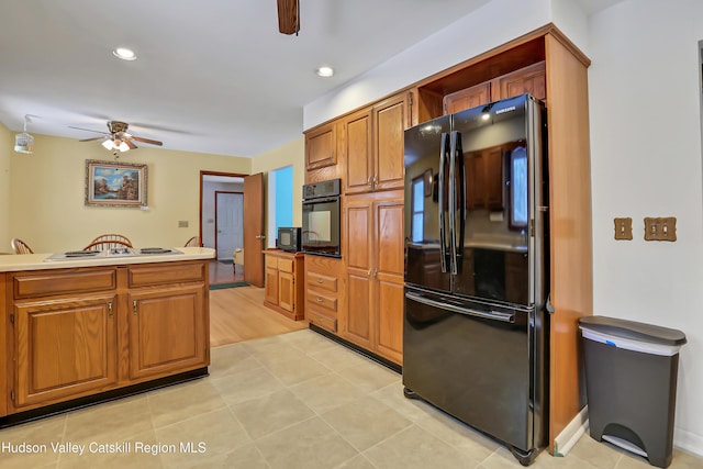 kitchen with ceiling fan and black appliances