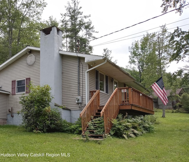 back of house with a yard and a deck