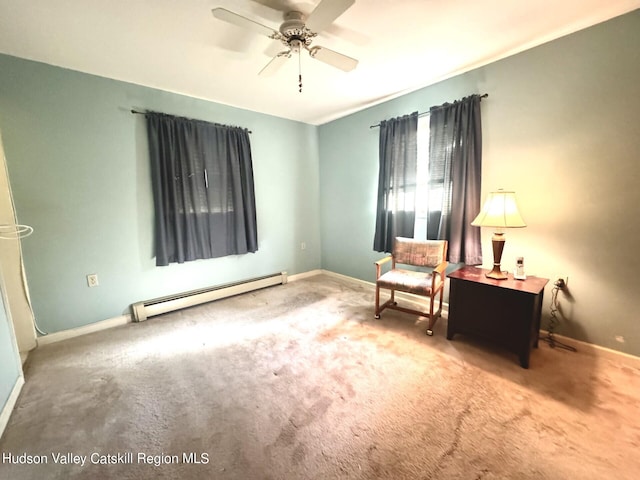 living area featuring ceiling fan, carpet floors, and a baseboard heating unit