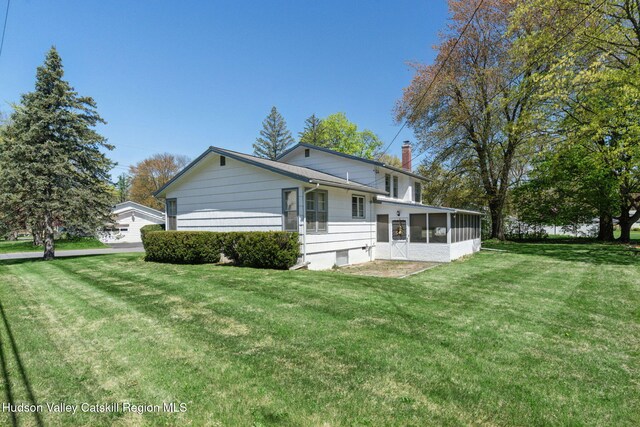 4 Schuler Ln, Lake Katrine, NY 12449 - rear view of house featuring a chimney, a sunroom, and a yard