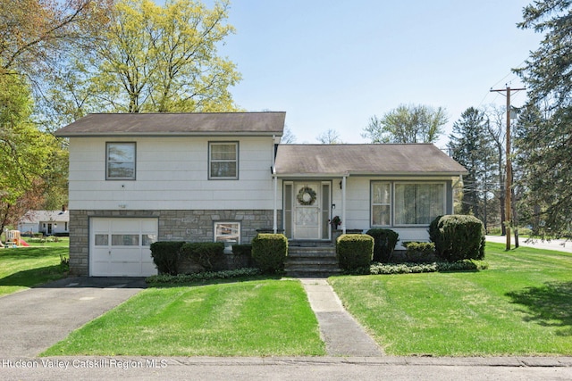 4 Schuler Ln, Lake Katrine, NY 12449 - tri-level home with driveway, an attached garage, a front lawn, and stone siding