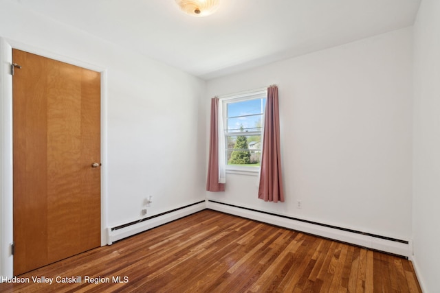 4 Schuler Ln, Lake Katrine, NY 12449 - spare room with wood finished floors and a baseboard heating unit