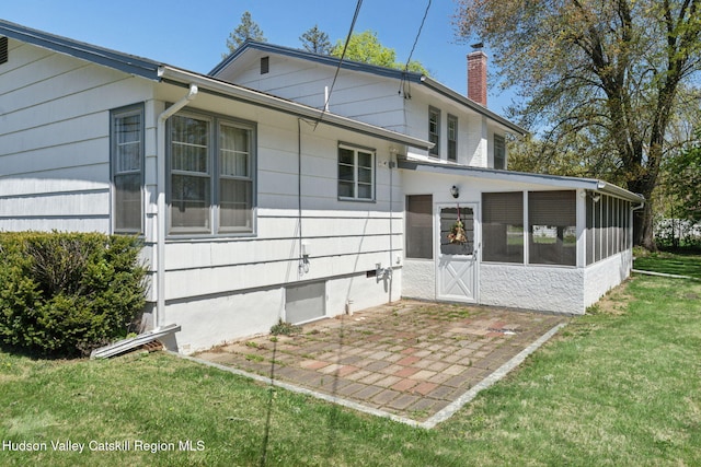 4 Schuler Ln, Lake Katrine, NY 12449 - back of house featuring a sunroom, a chimney, a lawn, and a patio area
