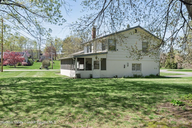 4 Schuler Ln, Lake Katrine, NY 12449 - view of home's exterior with a chimney, a lawn, a sunroom, and central AC