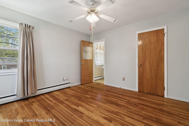 4 Schuler Ln, Lake Katrine, NY 12449 - unfurnished bedroom with a baseboard heating unit, wood finished floors, baseboards, and ensuite bathroom